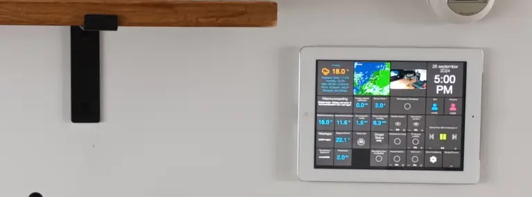 Wall-mounted iPad displaying a smart home AppDaemon dashboard, running on a Raspberry Pi with Docker containers.